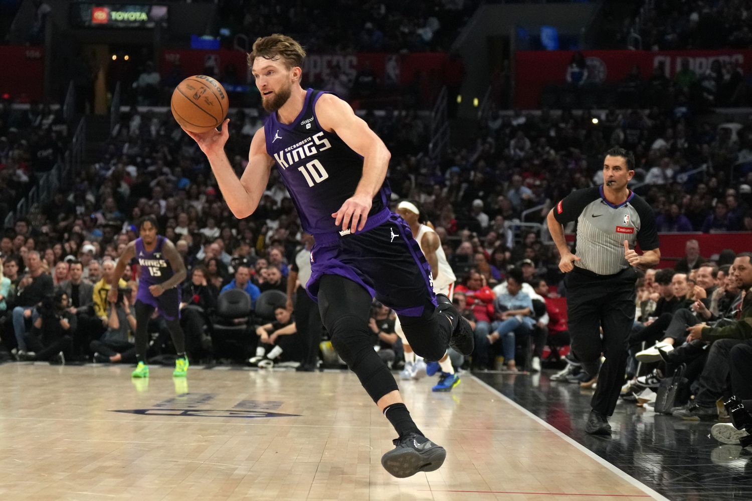 Feb 25, 2024; Los Angeles, California, USA; Sacramento Kings forward Domantas Sabonis (10) dribbles the ball against the LA Clippers in the second half at Crypto.com Arena. Mandatory Credit: Kirby Lee-USA TODAY Sports  